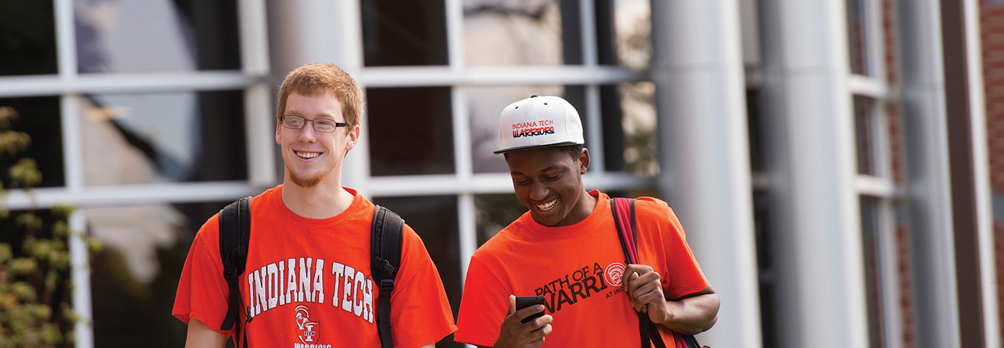 Two students walking across campus
