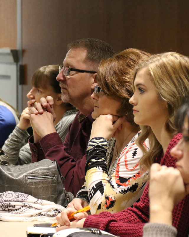 Business people listening to a speaker