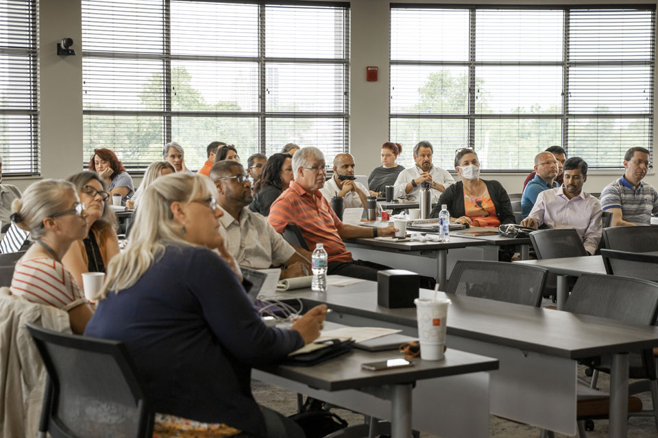 Professionals observing a lecture in the corporate engagement center