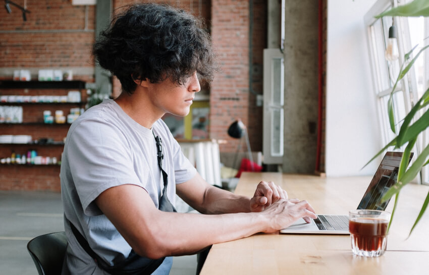 Student working at a computer in a coffee shop