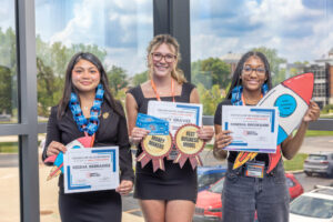 Students holding certificates of achievement