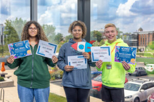 Students holding certificates of achievement