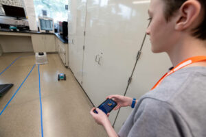 Student controlling a robotic car