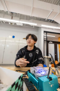 student at a soldering station
