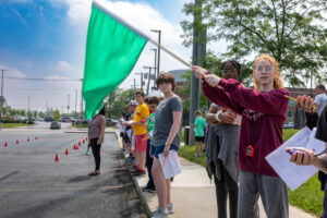 Camper holding a start flag