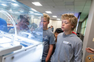 Campers watching a 3D Printer