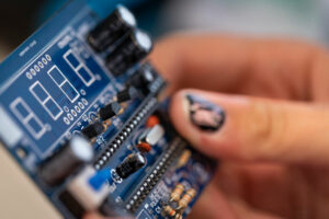 Student holding a circuit board