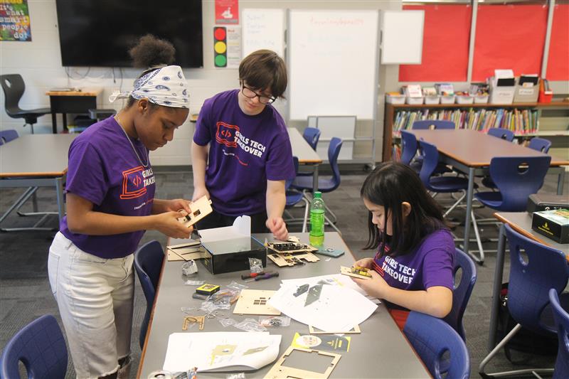 Girls working on a laser cut STEM project 