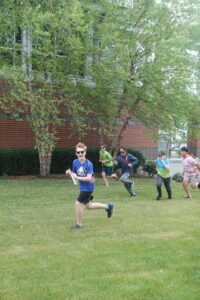 students running across campus