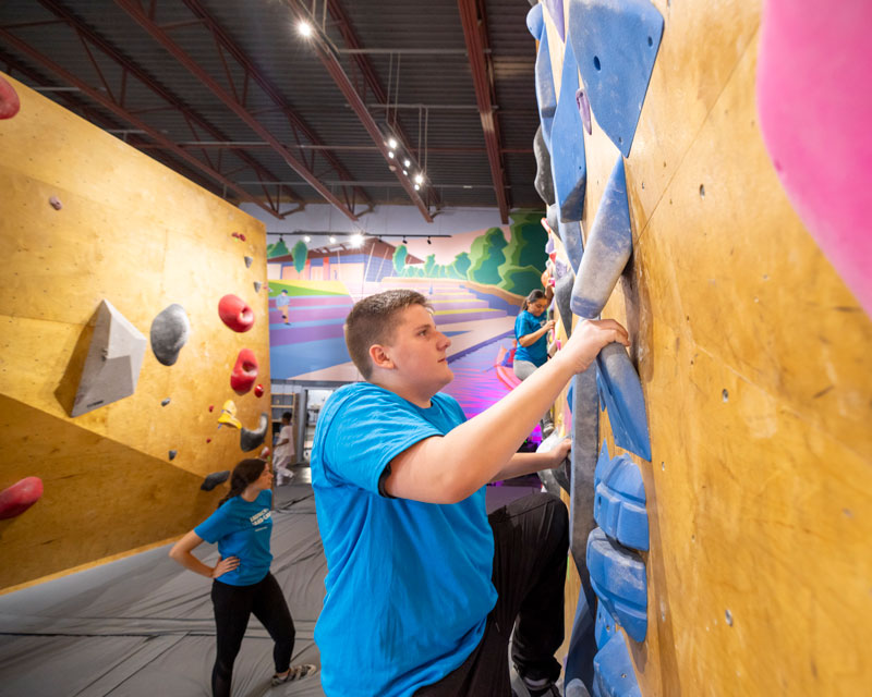 Students bouldering at Summit Climbing Club