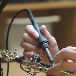 Student soldering a circuit board