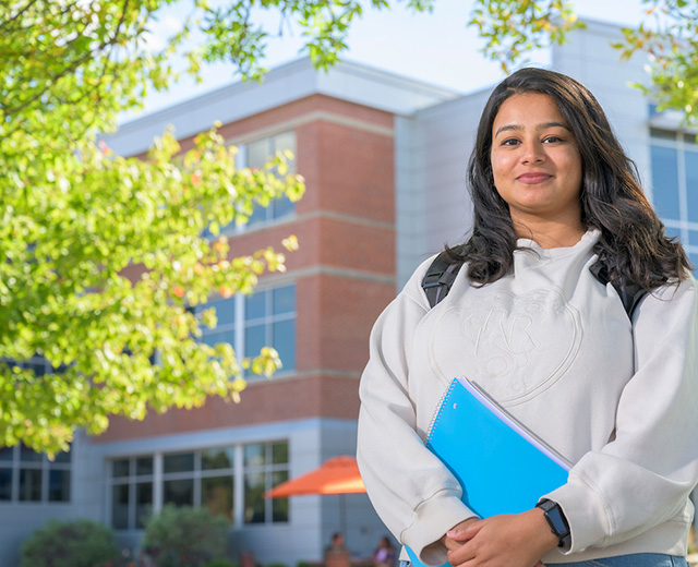Indiana Tech student standing in front of Cunningham Business Center
