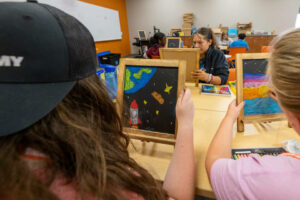 Creative Expression campers do chalk art