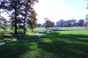 Trail winding through the green grass and slopes of the Donald Ross Golf Course on a beautiful day