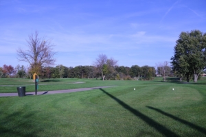 Trail winding through the green grass and slopes of the Donald Ross Golf Course on a beautiful day