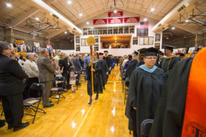 Previous Faculty of the Year award winner Sherrill Hamman leading the honored guests, vps and board of trustees during the inauguration ceremony