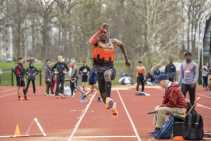 Indiana Tech track athlete completing a long jump