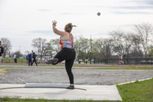 Indiana Tech student athlete throwing a shot put