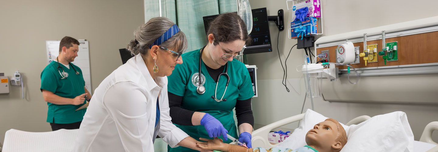 student practicing phlebotomy on a dummy