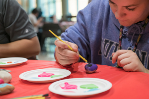 A student painting a hope rock