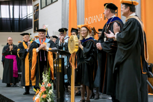 Honor guests and Board of Trustees members congratulating former President Arthur Snyder during President Karl W. Einolf's inauguration