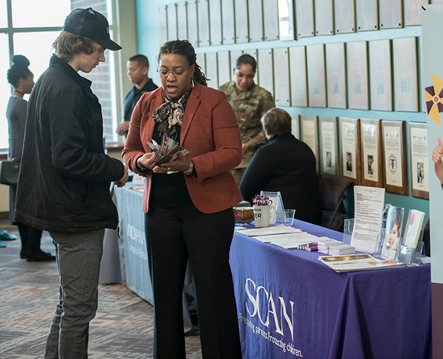 rep from local organization meeting with a student