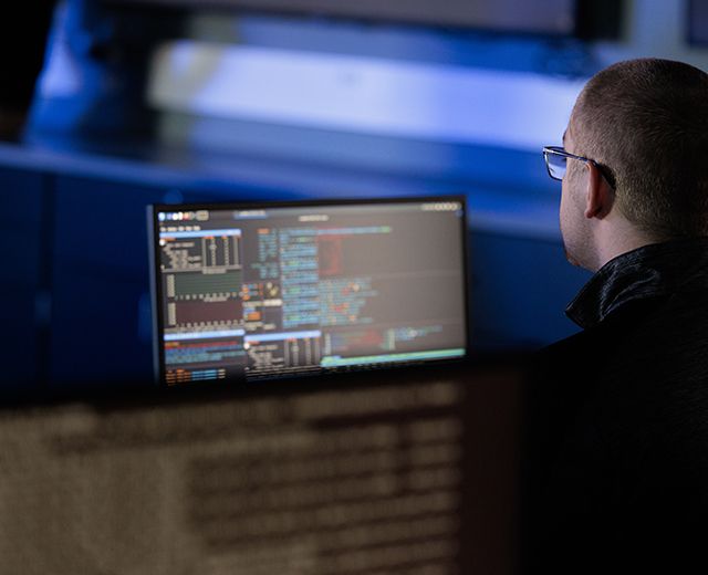 a person sitting at a desk doing cybersecurity