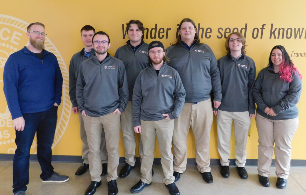 The Cyber Warriors offensive security team, from left to right: Coach Matt Hansen, John Allen Rudolph, Garrett Bates, Myles Nieman, Bryce Murphy, Samuel Regelbrugge and Nia Iott. Jeremy MacRoberts is not pictured.