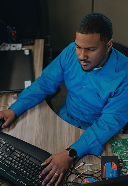 Graduate Desmond working on electronics