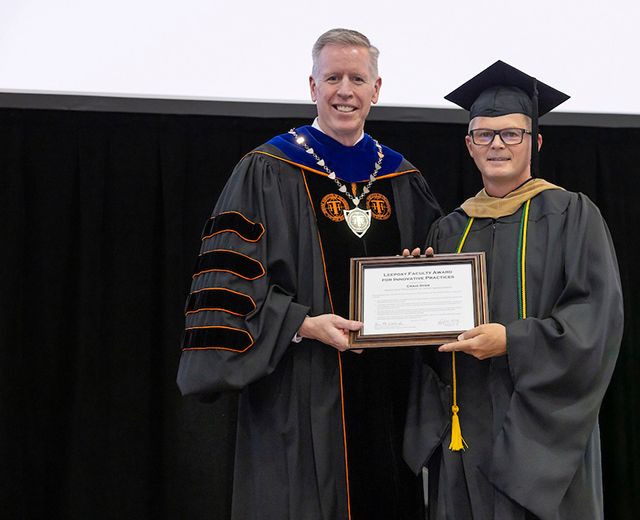 President Karl Einolf, left, assistant professor of sport management, Craig Dyer, right