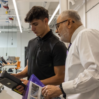 Professor Maximo Ortega teaching a student robotics programming