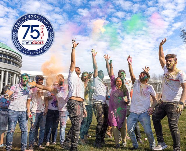photo of students throwing colored powder into the air during diwali