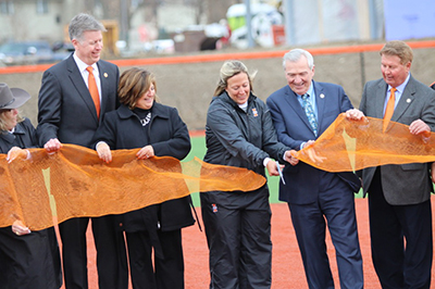 fort wayne mayor tom henry and indiana tech softball coach stephanie zimny cut the ribbon to open Indiana Tech's new softball stadium